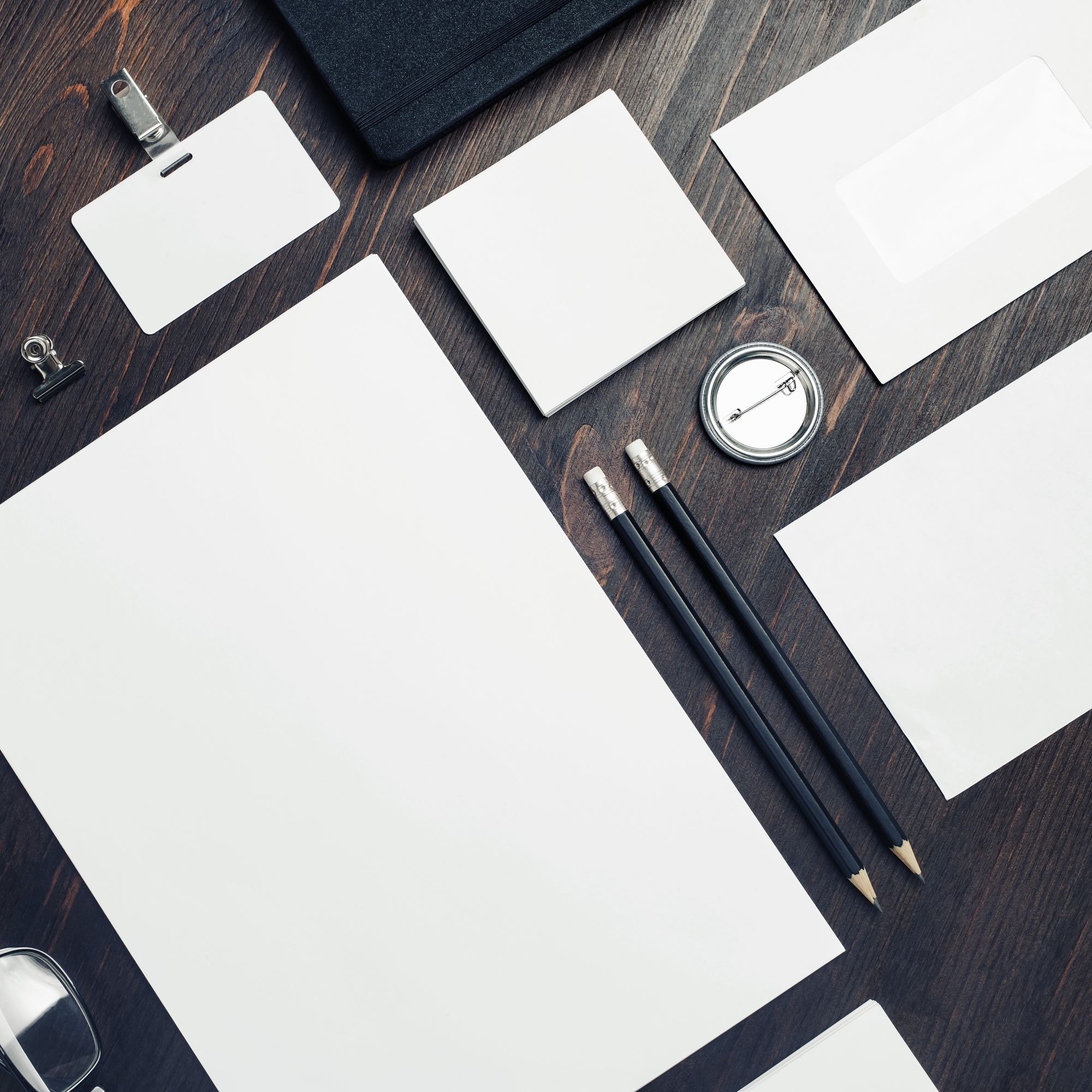 Brand stationery flat lay on dark concrete